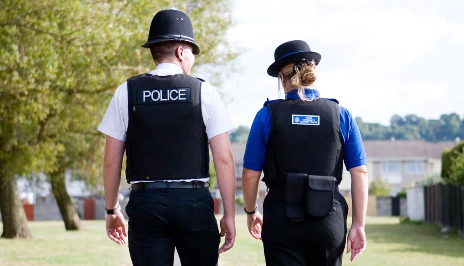 Local police officers walking through a park